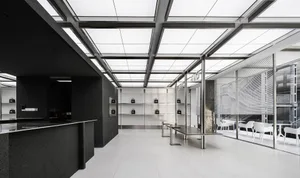 Empty modern room with white walls, black cabinets, and well-lit space
