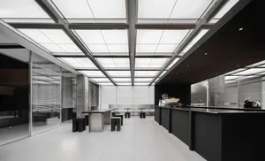 Modern restaurant interior with a large dining area, multiple tables, chairs, and couches, featuring a sleek and functional design