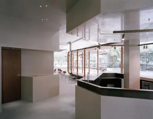 Modern restaurant interior with a large bar area, comfortable seating, and a focus on functionality and comfort