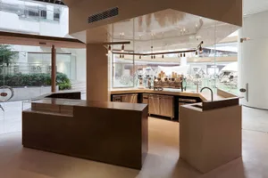 Commercial kitchen with multiple appliances, clean and well-organized, with cups and kitchen utensils visible