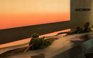 A warm and inviting kitchen display featuring a concrete countertop with arranged fruits and vegetables