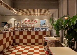 Inviting restaurant interior with a counter and chairs, displaying a variety of food items and providing a comfortable dining experience