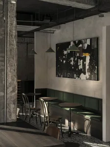 Modern restaurant interior with multiple tables, couches, and chairs, creating a comfortable and inviting atmosphere