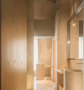 A modern bathroom with two sinks, two overhead lights, and a large mirror on one wall, giving a clean and well-lit impression