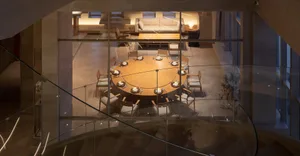 Inviting dining area with a large table, comfortable couch, and various place settings