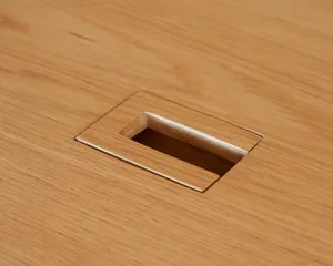 A wooden table with a central hole, featuring a simple design and minimal details