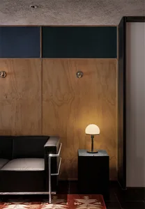 A well-lit living room with a couch, chair, and lamp, creating a comfortable atmosphere