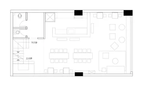 A calm and inviting commercial space with a large dining table and chairs, set up for customers