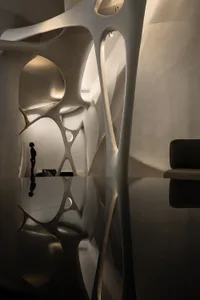 A minimalist hotel lobby with a large white wall, clean design, and a sense of calmness and elegance