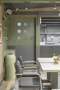 A cozy kitchen dining space with a wooden table surrounded by metal chairs, creating a warm and inviting atmosphere for meals and gatherings