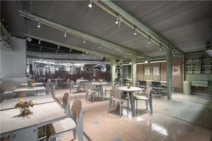 A warm and inviting dining area with multiple tables and chairs, perfect for socializing and enjoying meals together