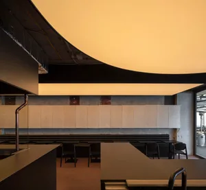 A well-lit restaurant dining area with a wooden table and chairs, creating a comfortable seating arrangement
