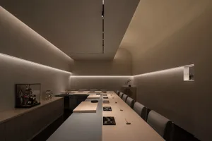 Empty modern conference room with a long wooden table and chairs, featuring a clean and minimalist design