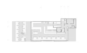 2D floor plan of a modern commercial building with concrete and glass materials, featuring various rooms and spaces, including a central atrium and offices