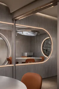 A modern dining area with a round wooden table surrounded by four metal chairs, creating an inviting atmosphere
