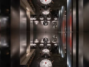A modern restaurant dining area with multiple tables and chairs, featuring a stylish and inviting atmosphere