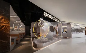 A modern showroom with a large glass sphere as its centerpiece, surrounded by chairs and dining tables, with a clean and contemporary feel