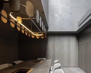 A modern dining space with a marble table surrounded by chairs, creating a sophisticated atmosphere