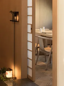 Warm and inviting dining area with a wooden table, chairs, and a bowl and cups on the table