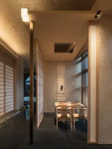 A wooden dining table surrounded by chairs in a warm and inviting space for gatherings and meals