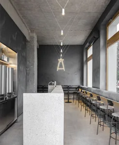 Modern restaurant interior with a marble countertop, chairs, and a sophisticated atmosphere