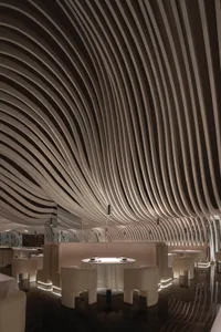 A modern restaurant interior with multiple dining tables and chairs, creating a comfortable and inviting atmosphere for guests
