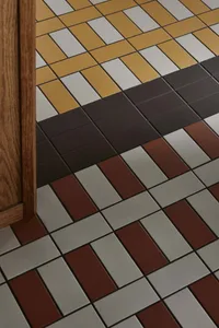 A well-lit room with a checkered floor made of ceramic tiles, adding a decorative touch to the space