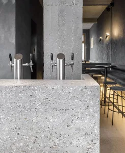 Industrial kitchen with two metal sinks, two chairs, and a functional atmosphere