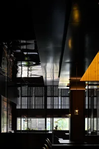 Elegant restaurant interior with multiple dining tables and chairs, clean lines, and minimalist design elements