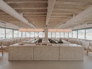 Open restaurant interior with wooden tables and chairs, providing ample seating options for guests in a spacious and inviting atmosphere