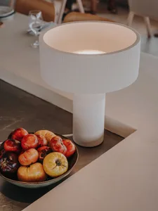 A dining table with fruits and wine glasses in a cozy and welcoming environment