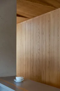 A wooden wall with a rustic appearance, possibly from a bathroom or closet, with visible wood planks