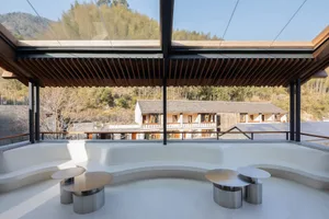 A modern open space with a glass ceiling, round tables, and a bright and airy ambiance