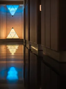 Wooden hallway with a large triangle shape, two lights, and a calm atmosphere