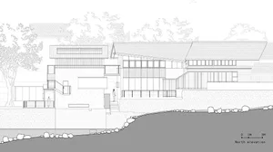 Top-down view of a modern house with open-plan living areas, a staircase, and multiple windows