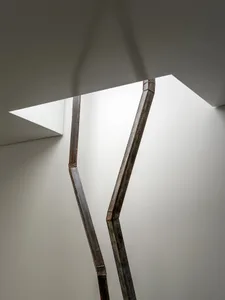 Modern interior space with metal sculptures integrated into the walls, creating a sophisticated atmosphere with well-lit surroundings