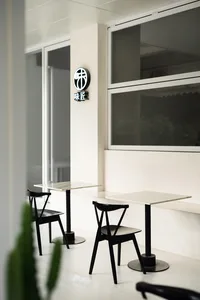 A dining area with multiple tables and chairs, creating an inviting atmosphere for social gatherings