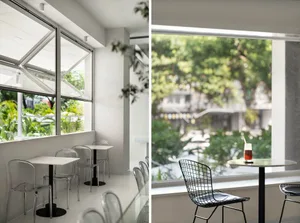 A restaurant with multiple dining tables and chairs, both inside and out, creating a welcoming atmosphere for guests
