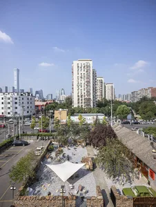 A bustling city scene with modern concrete and glass buildings, cars, and people going about their daily activities