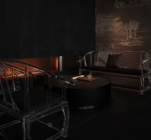 Asian-inspired living area with two couches, chairs, and a dining table in a room with a black wall and modern style