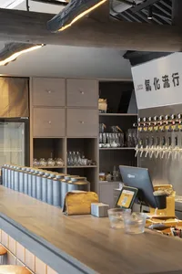 A lively Asian restaurant bar with numerous beer taps and bottles, and scattered cups, inviting customers to enjoy a variety of drinks
