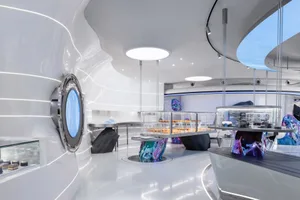 Sleek modern kitchen and dining space with a circular table, chairs, and minimal decorations