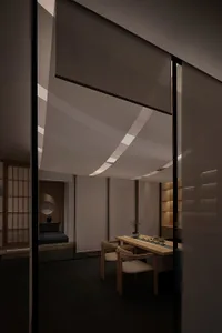 Cozy Asian-style living space with a dining table, chairs, and a bed, featuring warm and inviting traditional design elements
