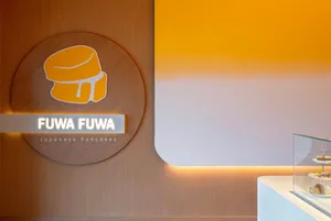 A well-lit Asian restaurant with a yellow sign featuring Japanese text reading Wawa
