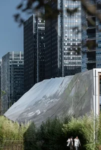 A cityscape with a mix of modern and traditional buildings, featuring glass and reflective surfaces, set against a vibrant urban backdrop