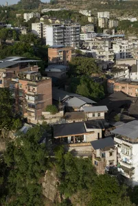 A cityscape with a mix of residential and commercial buildings, featuring a blend of architectural styles, neutral tones, and natural lighting