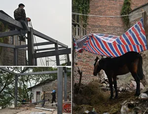 Construction site with a brick building, men working, a horse, and a person holding a metal beam