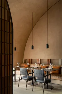 Elegant dining space with a round table, wine glasses, and decorative elements