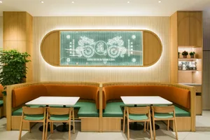 A cozy restaurant interior with wooden tables and chairs, inviting atmosphere, and comfortable seating options