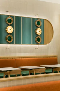 Modern restaurant interior with wooden tables and chairs, inviting atmosphere, and stylish decor